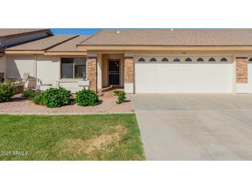 Charming single-story home with a well-manicured lawn and inviting front entrance, showcasing a beautiful facade at 11250 E Kilarea Ave # 276, Mesa, AZ 85209