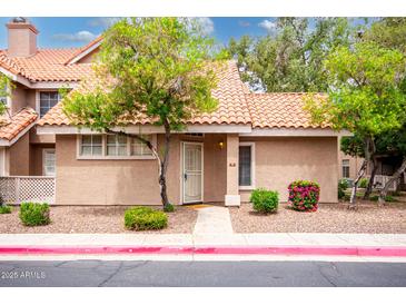 Charming home featuring desert landscaping, including beautiful trees and shrubs at 1633 E Lakeside Dr # 48, Gilbert, AZ 85234