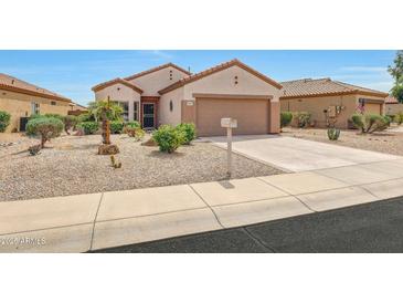 Charming single-story home with desert landscaping and a two-car garage at 16427 W Labyrinth Ln, Surprise, AZ 85374