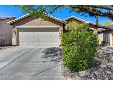 Charming home featuring a two-car garage, well-maintained landscaping, and a neutral color palette at 16820 N 152Nd Ln, Surprise, AZ 85374