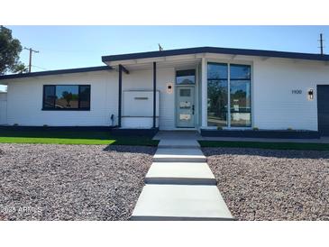 Charming single-story home with modern updates, a landscaped yard, and walkway at 1920 N Cavalier Dr, Tempe, AZ 85288