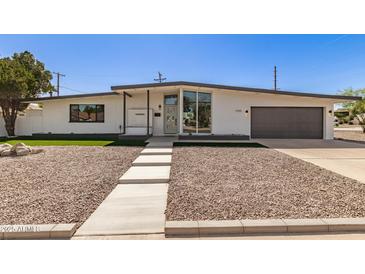 Beautiful single-story home featuring a modern design, gray accents, and a landscaped front yard at 1920 N Cavalier Dr, Tempe, AZ 85288