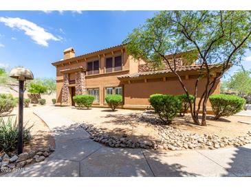 Charming two-story home featuring stone accents, a tiled roof, and well-maintained landscaping at 19700 N 76Th St # 1151, Scottsdale, AZ 85255