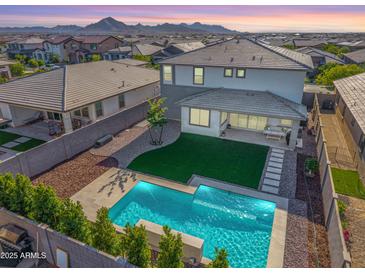 Aerial view of a sparkling pool and backyard with mountain views at 25725 S 230Th St, Queen Creek, AZ 85142