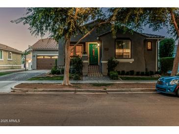 Charming home exterior with a well-manicured lawn, welcoming entrance and attached garage, creating curb appeal at 2721 E Tamarisk St, Gilbert, AZ 85296