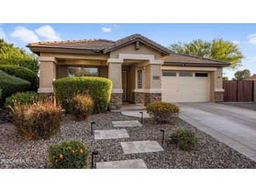 Charming home with a well-maintained front yard, stone accents, and welcoming walkway at 2823 E Charlotte Dr, Phoenix, AZ 85024