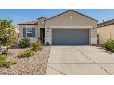 Charming single-story home featuring a neutral color scheme, desert landscaping, and a spacious two-car garage at 5079 E Emery Rd, San Tan Valley, AZ 85143