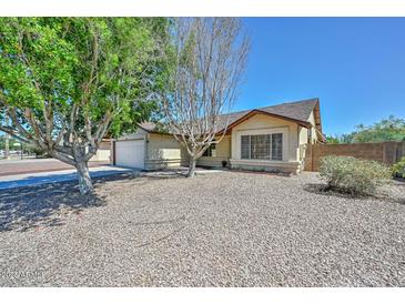 Charming single-story home with desert landscaping and a two-car garage at 6623 N 85Th Ave, Glendale, AZ 85305