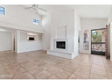 Bright living room featuring a fireplace, tile floors, and an open layout connecting to the kitchen at 7800 E Lincoln Dr # 2092, Scottsdale, AZ 85250