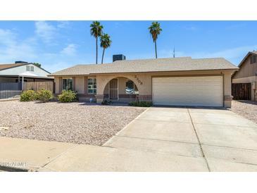 Charming single-story home with low maintenance gravel front yard and attached two car garage at 2305 E Glade Ave, Mesa, AZ 85204