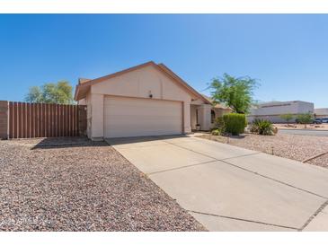 Traditional home with neutral siding, desert landscaping, a long driveway, and an attached two car garage at 2509 N Cheri Lynn Dr, Chandler, AZ 85225