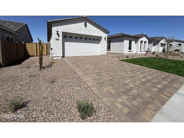 Charming single-story home featuring an attached garage and a nicely paved driveway in a well-maintained neighborhood at 26232 N 77Th Dr, Peoria, AZ 85383