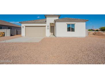 Charming single-story home with a beige color scheme and a well-maintained desert landscape at 34865 N Palm Dr, San Tan Valley, AZ 85140