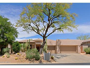 Charming single-story home featuring xeriscaping, a tile roof and a two-car garage at 6714 E Amber Sun Dr, Scottsdale, AZ 85266
