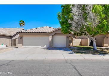 Charming single-story home with a three-car garage and well-maintained front yard at 902 W Saragosa St, Chandler, AZ 85225