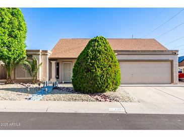 Charming single-story home featuring a low-maintenance yard, desert landscaping, and a two-car garage at 1207 E Sequoia Dr, Phoenix, AZ 85024