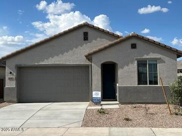 Charming single-story home featuring a two-car garage and desert landscaping for low maintenance at 25146 W Wayland Dr, Buckeye, AZ 85326
