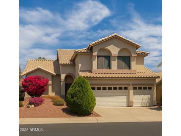 Charming two-story home with a three-car garage and well-maintained landscaping at 21483 N 65Th Ave, Glendale, AZ 85308
