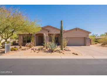 Charming single-story home with desert landscaping, including mature cacti and a paved driveway at 8703 E Nora St, Mesa, AZ 85207
