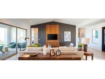 Comfortable living room featuring modern decor, a large sectional sofa, and access to a patio at 9924 E Strobe Ave, Mesa, AZ 85212
