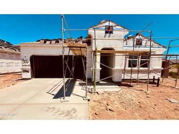 New construction home featuring a two-car garage and a modern architectural design at 11946 E Cliffrose Ln, Florence, AZ 85132
