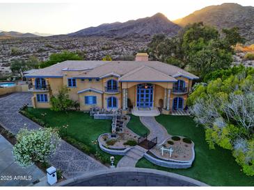 Elegant two-story home with a well-manicured lawn, water feature, and mountain views at 12240 S Honah Lee Ct, Phoenix, AZ 85044