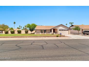 Charming single-story home featuring a well-manicured lawn and a two-car garage with inviting curb appeal at 1210 W Stottler Dr, Chandler, AZ 85224