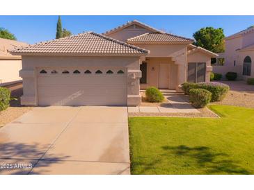 Charming single-story home featuring a well-maintained lawn and a two-car garage at 1463 W Mead Dr, Chandler, AZ 85248