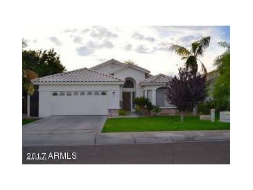 Charming single-story home featuring a manicured lawn and attached two-car garage at 3152 N 83Rd Pl, Scottsdale, AZ 85251