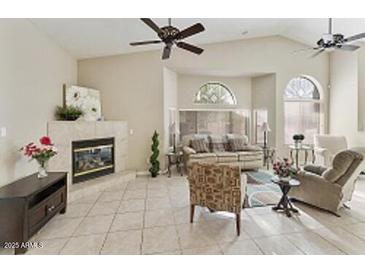 Bright living room with tile floors, fireplace, ceiling fans, and lots of natural light at 4202 E Broadway Rd # 40, Mesa, AZ 85206