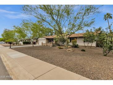 Charming single-story home with desert landscaping and mature shade trees in a quiet neighborhood at 4840 E Sunnyside Dr, Scottsdale, AZ 85254