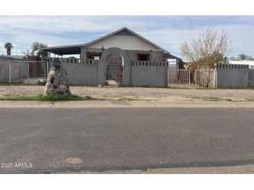 Quaint single story home featuring a gated front yard and stone accents in a residential area at 509 W 12Th St, Casa Grande, AZ 85122