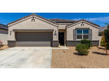 Charming single-story home with a two-car garage, desert landscaping, and a cozy front entrance at 5146 E Diatomite Dr, San Tan Valley, AZ 85143