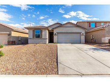 Charming single-story home with a well-maintained yard and a spacious two-car garage at 11505 W Boca Raton Rd, El Mirage, AZ 85335