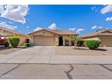Charming single-story home with a well-maintained front yard and attached two-car garage at 1462 E Poncho Ln, San Tan Valley, AZ 85143
