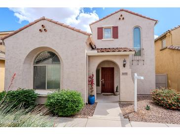 Inviting home exterior showcases a red-tile roof, stucco facade, arched window, and well-manicured landscaping at 16017 N 19Th Dr, Phoenix, AZ 85023