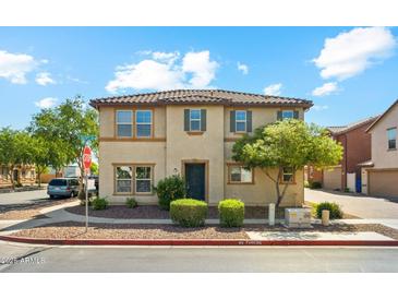 Charming two-story home with a tile roof and desert landscaping on a sunny day at 523 N Ranger Trl, Gilbert, AZ 85234