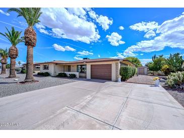Charming single-story home boasts a well-manicured yard and attached two-car garage at 6041 E Colby St, Mesa, AZ 85205