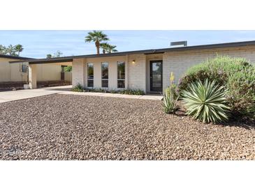 Charming home featuring desert landscaping and a well-maintained facade with a covered parking area at 845 E Village Circle S Dr, Phoenix, AZ 85022