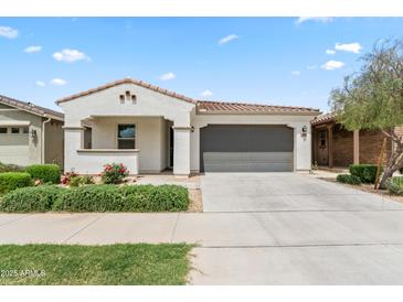 Charming single-story home featuring a well-manicured lawn, neutral color palette, and a two-car garage at 9728 E Twinkle Ave, Mesa, AZ 85212