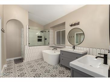 Beautiful bathroom with a soaking tub, walk-in shower, dual sink vanity, and decorative tile flooring at 16014 S 13Th Way, Phoenix, AZ 85048