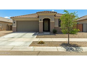 Charming single-story home with desert landscaping and a two-car garage at 17219 W Gibson Ln, Goodyear, AZ 85338