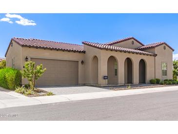 Charming single-story home with a two-car garage, arched entryway, and red tile roof at 17279 W Dartmouth St, Surprise, AZ 85388