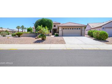 Charming single-story home with a two-car garage and attractive desert landscaping for easy care at 17371 N Natura Trl, Surprise, AZ 85374