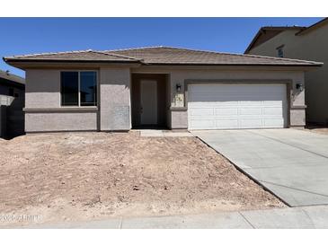 Charming single-story home featuring a two-car garage, desert landscaping potential, and neutral color palette at 17482 W Fulton St, Goodyear, AZ 85338