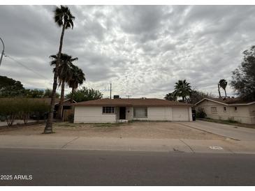 Charming single-story home with a well-maintained exterior and desert landscaping at 1807 W Hazelwood St, Phoenix, AZ 85015
