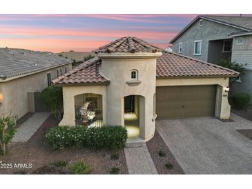 A charming turret entry highlights this home with low maintenance desert landscaping at 20607 W Point Ridge Rd, Buckeye, AZ 85396