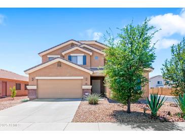 Charming two-story home with a well-manicured lawn, a two-car garage, and desert landscaping at 23955 W La Salle St, Buckeye, AZ 85326