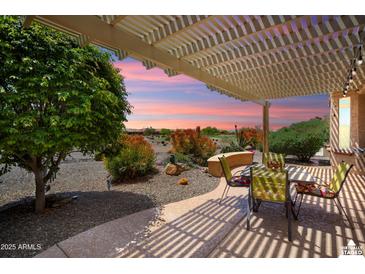Virtually staged covered patio showcasing an idyllic evening setting, desert views, and outdoor dining at 26725 W Marco Polo Rd, Buckeye, AZ 85396