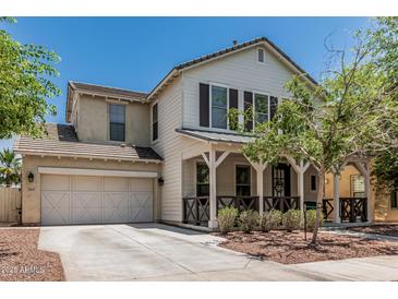 Charming two-story home with a welcoming front porch, well-manicured landscaping, and a convenient two-car garage at 3109 N Black Rock Rd, Buckeye, AZ 85396